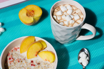 Cereal porridge with fruit and milk.