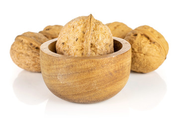 Fototapeta na wymiar Group of five whole ripe brown walnut in tiny wooden bowl isolated on white background