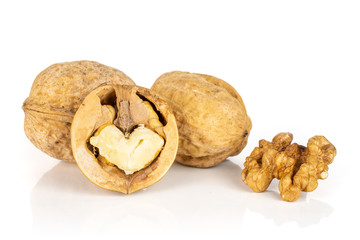 Group of two whole two halves of ripe brown walnut isolated on white background
