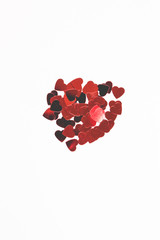 Sparkle confetti of heart. Red confetti on white background. Holidays concept.