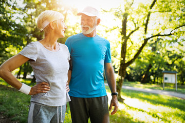Happy senior couple staying fit by sport running