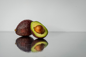sliced avocado on a mirrored background