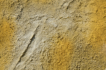 Yellow-gray cement wall. Abstract decorative stucco background.