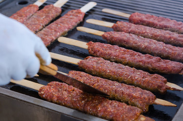 Cooking adana kebabs on a grill in restaurant 