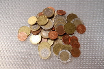 a large pile of metal coins of the European Union in bulk