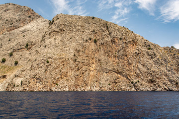 Fototapeta na wymiar Boat trip along the shore of the island of Symi