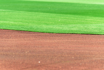 Clean and perfect line between baseball field infield dirt and outfield grass.