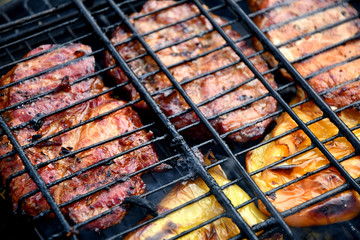 Barbecue outdoors steak and bell pepper in the smoke on the grill.