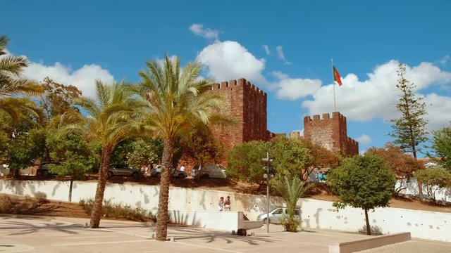 Wide view of the Castle of Silves, in The Algarve, Portugal, with its distinctive red sandstone and history dating back to 201 BC