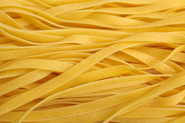 Tasty raw egg noodles as background, top view