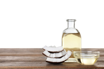 Composition with natural organic coconut oil on wooden table against white background. Space for text