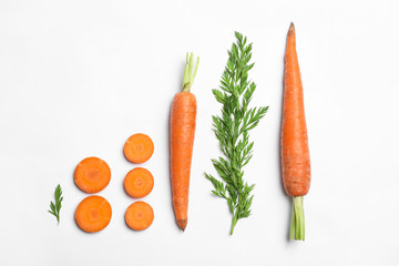 Tasty ripe carrots and leaves isolated on white, top view