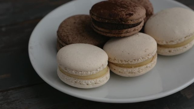 Sweet French coffee macaroons on white plate