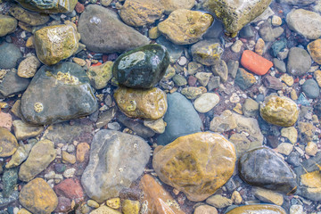 Stones in the clear sea water. Stones background.