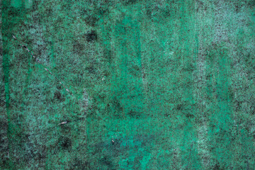 Green grunge painted wall surface worn weathered dirty old rough vintage background surface texture