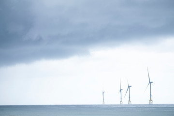 Wind turbines at electric power farm in the North Sea in Aberdeen for renewable energy production...