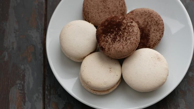 Sweet French coffee macaroons on white plate