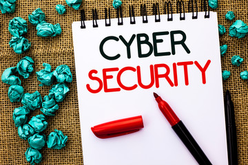 Writing note showing Cyber Security. Business photo showcasing Online prevention of attacks Viruses Encrypt Information written Notebook Book the jute background Markers next to it.