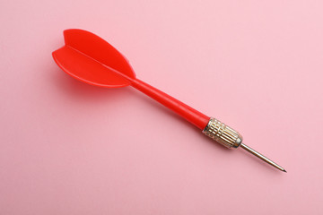 Red dart arrow on pink background, top view