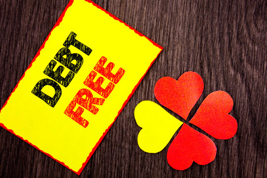 Text showing Debt Free. Business photo showcasing Credit Money Financial Sign Freedom From Loan Mortage written Sticky Note Paper with Love Heart Next to it the wooden background.
