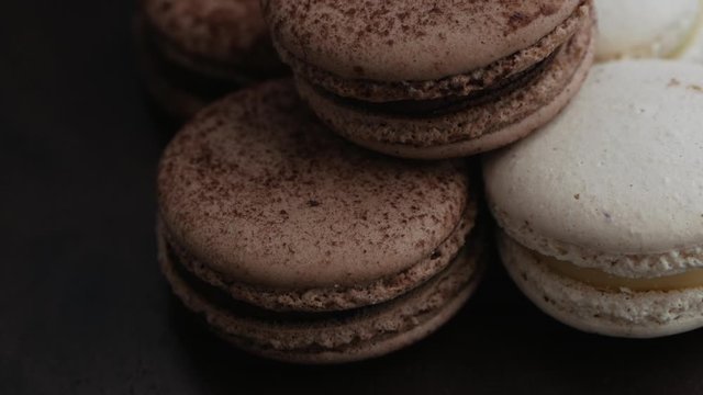 Sweet French coffee macaroons on white plate closeup
