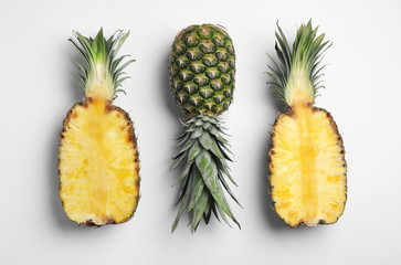 Tasty ripe pineapples on white background, top view