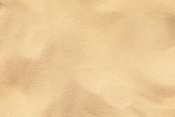 Naklejka na ściany i meble Golden beach sand on sunny day as background