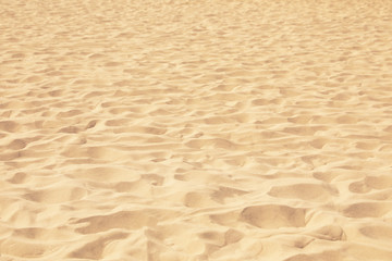 Fototapeta na wymiar Golden beach sand on sunny day as background