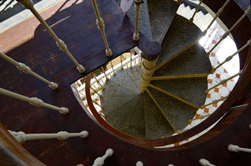 Old wooden spiral staircase connecting the floors of Chateau de Labourdonnais, a colonial palace,...