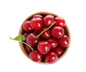 Wooden bowl of delicious ripe sweet cherries on white background, top view