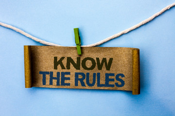 Handwriting text Know The Rules. Concept meaning Be aware of the Laws Regulations Protocols Procedures written Cardboard Paper hanging on rope the plain background Clip.