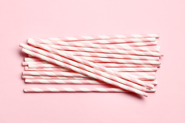 Pink paper straws on a pink background with place for text.