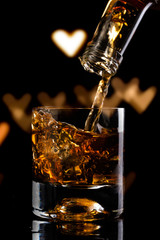 glass of whiskey and ice cube