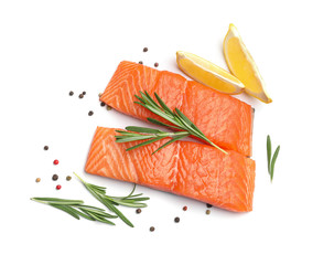 Fresh raw salmon fillets with rosemary and lemon on white background, top view