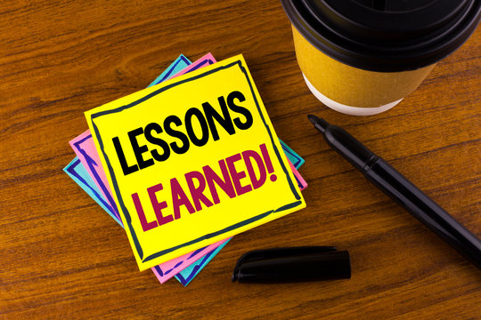 Word writing text Lessons Learned Motivational Call. Business concept for Academic student development optimization written Sticky Note Paper wooden background Marker Cup next to it.