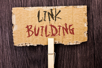 Word writing text Link Building. Business concept for Process of acquiring hyperlinks from other websites Connection written Cardboard Piece Holding With Clip the wooden background.