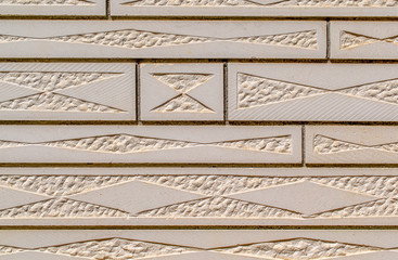 Stone wall cladding. Carved stone wall.
