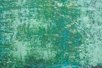 Green grunge painted wall surface worn weathered dirty old rough vintage background surface texture