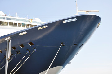 close-up of the nose of a large ship standing in the port and moored to the pier.