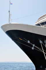 close-up of the nose of a large ship standing in the port and moored to the pier.