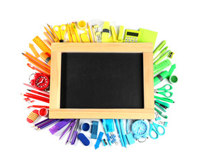 Composition with different school stationery and blank small chalkboard on white background, top view