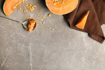 Flat lay composition with ripe cantaloupe melon on beige marble table. Space for text