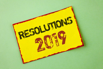 Word writing text Resolutions 2019. Business concept for Positive reinforcement personal improvent corporate goals written Yellow Sticky Note Paper the plain background.