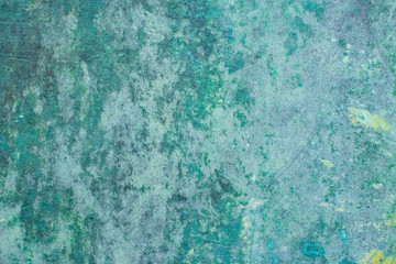Green grunge painted wall surface worn weathered dirty old rough vintage background surface texture