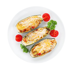 Baked stuffed zucchinis on white background, top view