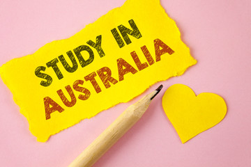 Writing note showing Study In Australia. Business photo showcasing Graduate from oversea universities great opportunity written Tear Yellow paper piece Pink background Heart next to it.