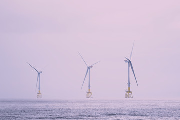 Wind turbines at electric power farm in the North Sea in Aberdeen for renewable energy production...