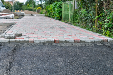 Paving new sidewalk with paving blocks