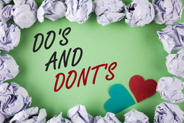 Text sign showing Do'S And Don'Ts. Conceptual photo What can be done and what cannot be knowing right wrong written plain green background within White Paper Balls Hearts next to it.