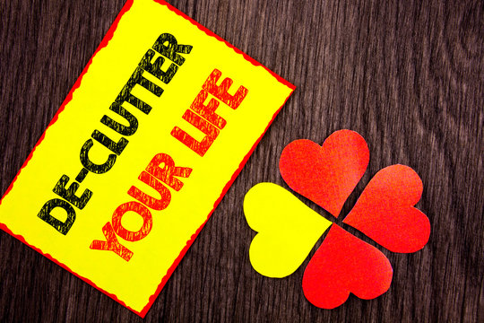 Text showing De-Clutter Your Life. Business photo showcasing Free Less Chaos Fresh Clean Routine written Sticky Note Paper with Love Heart Next to it the wooden background.